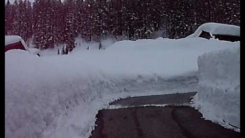In macchina sulla strada riscaldata ai bordi 2 metri di neve